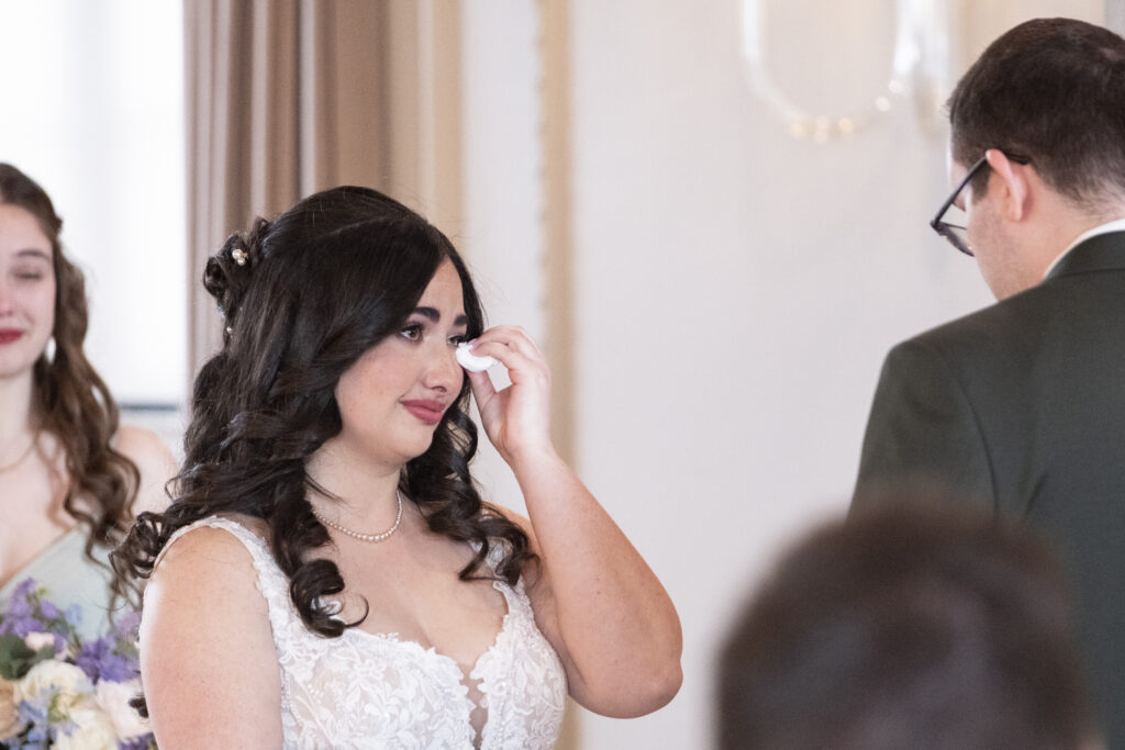 The bride reacts emotionally to her grooms vows at their wedding ceremony at the Elora Mill Foundry Chapel, in Elora, Ontario. 