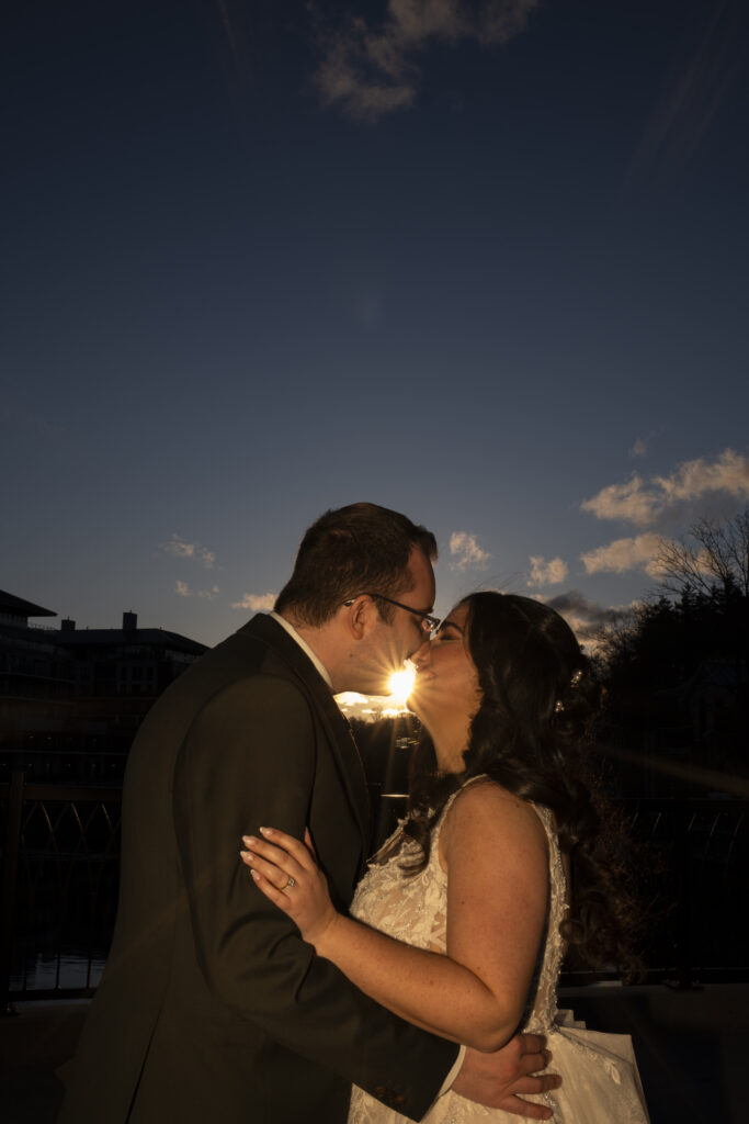 The bride and groom share a moment at golden hour on the bridge near the Elora Mill in Elora, Ontario. 