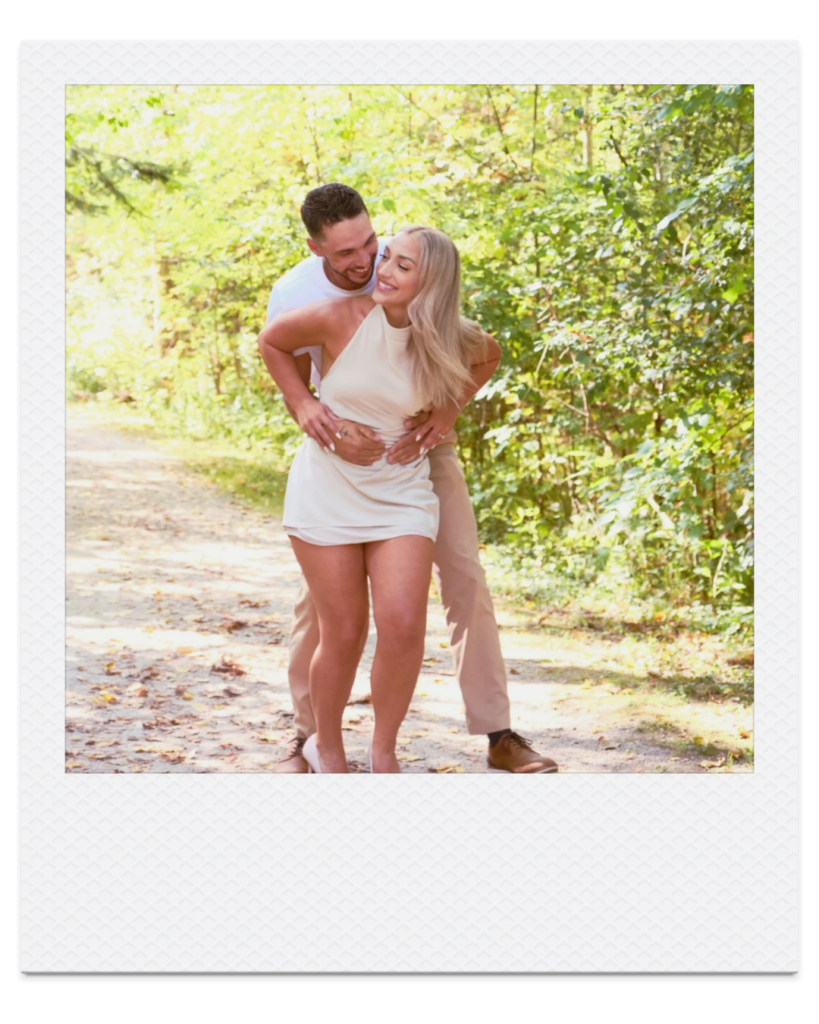 Couple laughing together during a playful fall engagement session at the Collingwood Arboretum.
