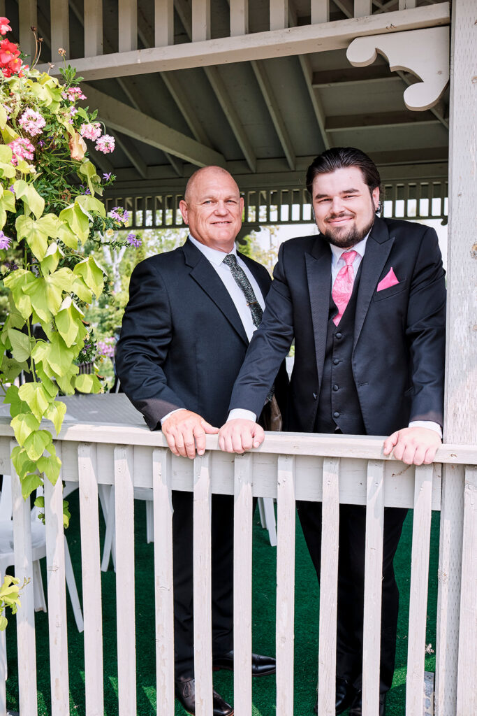 A groom and his father in the golf gazebo at Nottawasaga Inn Resort & Conference Centre during their wedding day in Alliston, Ontario.