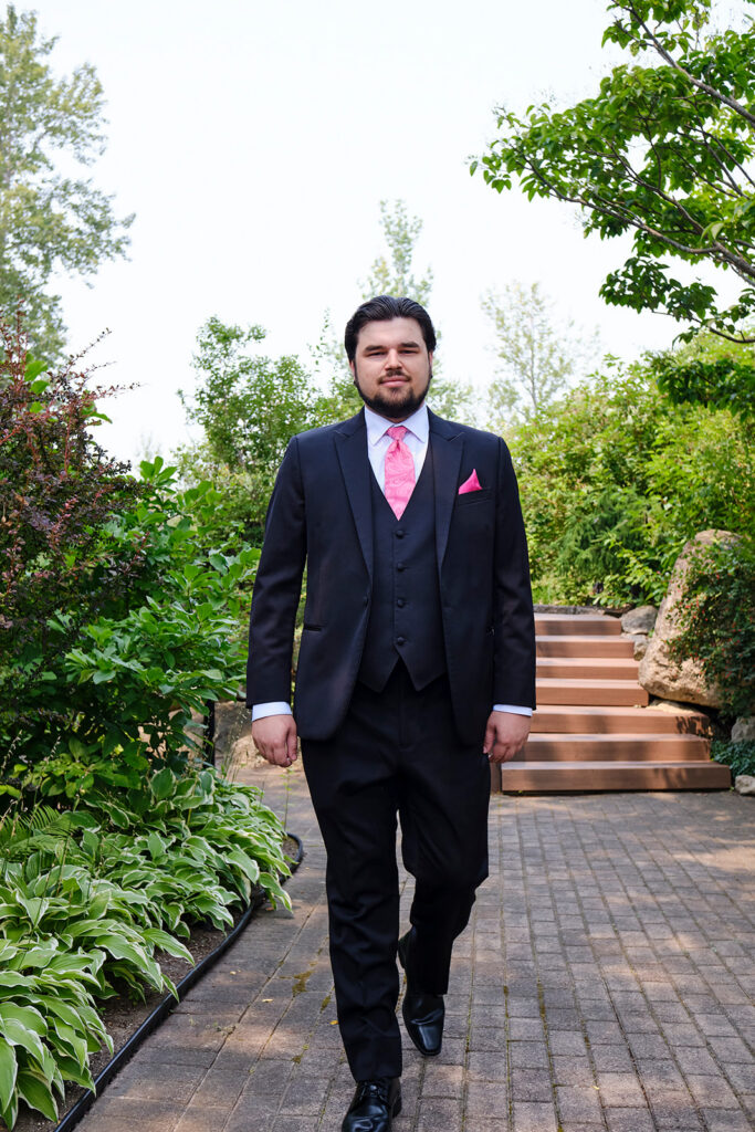 Groom walking at Nottawasaga Inn Resort & Conference Centre during their wedding day in Alliston, Ontario.