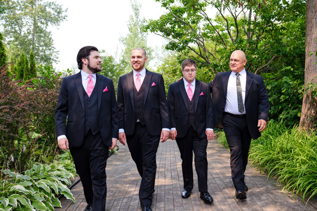 Groomsmen walking at Nottawasaga Inn Resort & Conference Centre during their wedding day in Alliston, Ontario.